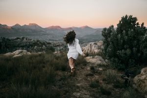 A person running on a trail in the mountains.